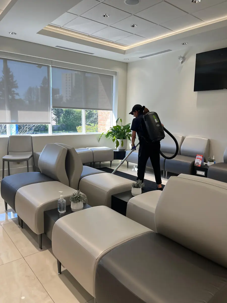 Office Care Pro cleaner vacuuming a clinic waiting room