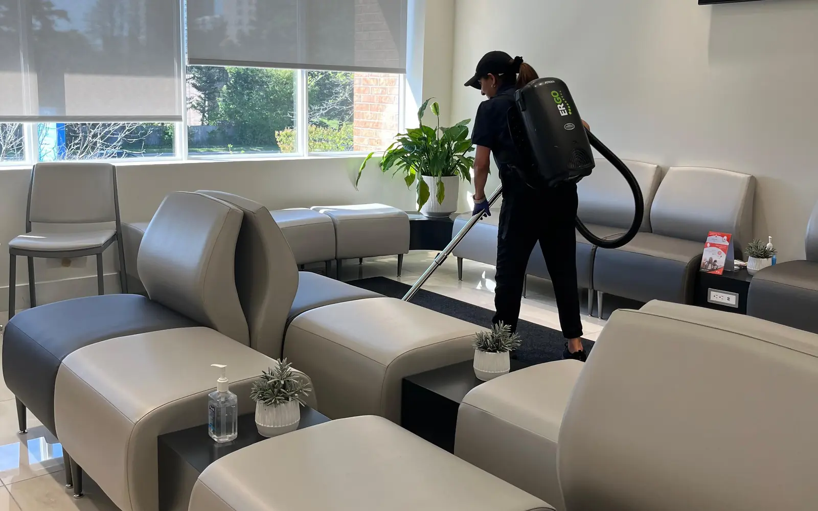 Office Care Pro cleaner vacuuming the waiting room of a clinic