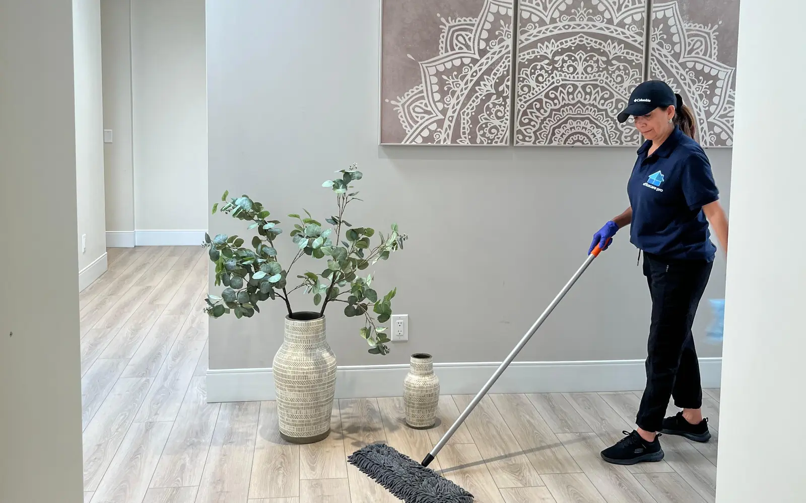 Office Care Pro cleaner mopping an office hallway